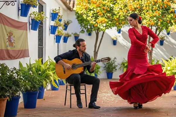 Tancerka flamenco i gitarzysta na słonecznym andaluzyjskim patio – tło oferty kursów języka hiszpańskiego (Online i w Katowicach) w Alma Española.
